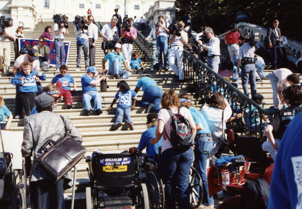 Protestors climbing U.S. Capitol building steps as a protest in favor of passing the ADA